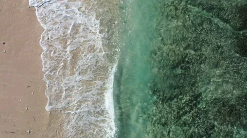 Waves breaking along a white sand beach in Bali Stock Footage 153726642