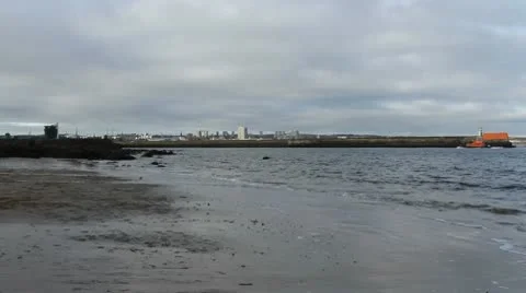 Waves breaking and Aberdeen skyline Scotland Stock Footage 10750326