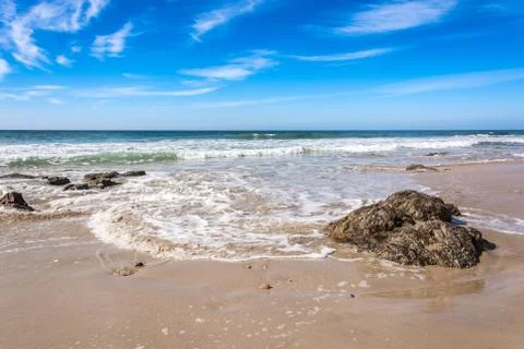 Waves breaking on beach with blue sky - Port Elizabeth, South Africa 写真素材