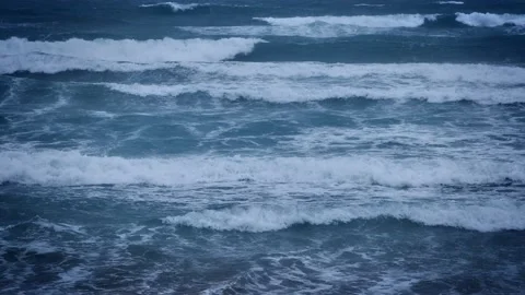 Waves breaking on a beach a dark stormy day Video stock 231670497