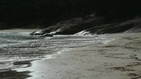 Waves breaking on beach Stock Footage 12360027