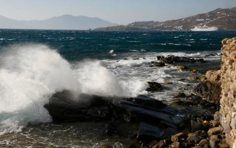 Waves breaking on the beach rocks Stock Photos