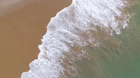 Waves breaking onto beach, top view Stock Footage 62857477