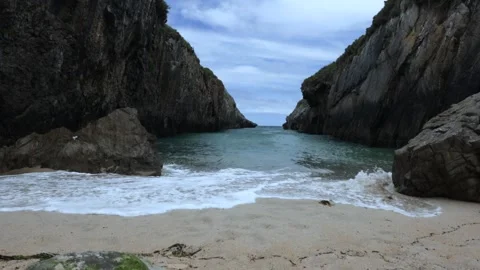 Waves breaking on a beautiful beach in slow motion in Asturias Stock Footage 242291362