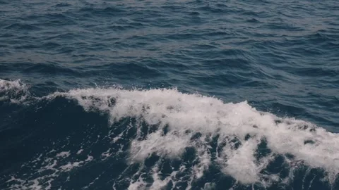 Waves breaking beside a moving boat, Mallorca coast Stock Footage 343440996