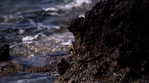 Waves Breaking On Black Coastal Rock, Backlit Evening Spray, Dramatic Close-Up Stock Footage 340626948