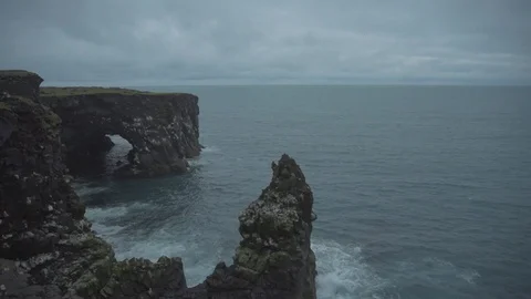 Waves breaking on the black rock cliff of western Icelandic coast, Svortuloft Stock Footage 94154367