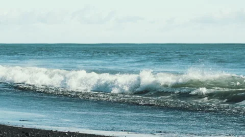 Waves breaking on a black sand beach in Iceland Video stock 348027230