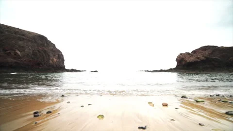 Waves breaking on black volcanic rocks Stock Footage 318786439