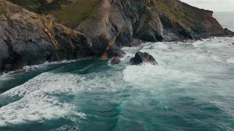 Waves breaking on cliff in sea Slomotion Portugal Algarve Amado aerial drone Stock Footage 196147278