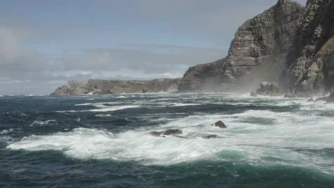 Waves breaking on cliffs at Cape Point, Cape Town, South Africa - Aerial View Stockbeeldmateriaal 319069084