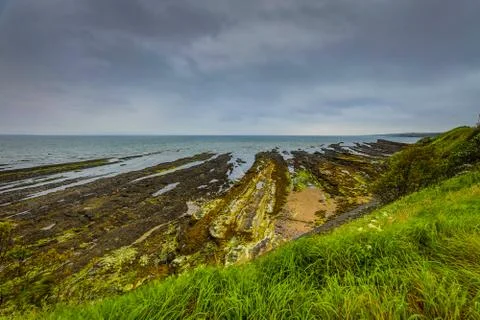 Waves breaking on coastal cliffs of Scotland. Stock Photos