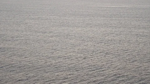 Waves breaking erosion eroding dark basalt rocks near shore. 動画素材 110761695