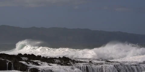 Waves breaking in foam on a rocky ledge along the Hawaiian coast Stock Footage 59525546