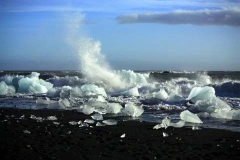 Waves breaking up the icebergs Stock Photos