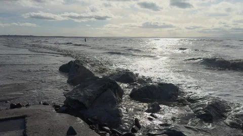 Waves breaking on incoming tide against sea wall Stock-Footage 329580119
