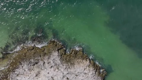 Waves Breaking onto Jagged Rocks Tropical Island Tide Pools Drone Stock Footage 288038593