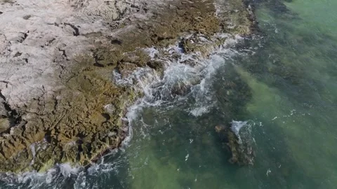 Waves Breaking onto Jagged Rocks Tropical Island Tide Pools Drone Stock Footage 288038600
