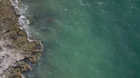 Waves Breaking onto Jagged Rocks Tropical Island Tide Pools Drone Stock Footage 288038606