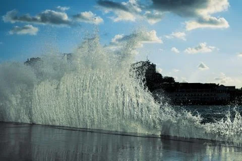 Waves breaking on the jetty Stock Photos