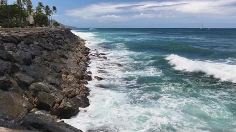 Waves breaking on jetty pier rocks, relaxing sunny day in paradise. Stock Footage 133827664