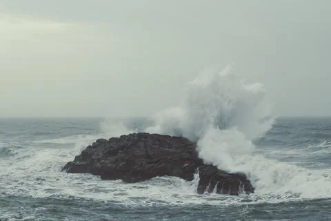 Waves breaking on large cliff landscape photo Фото
