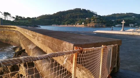 Waves breaking on the Lekeitio pier Stock Footage 133464304