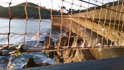 Waves breaking on the Lekeitio pier Stock Footage 133464350