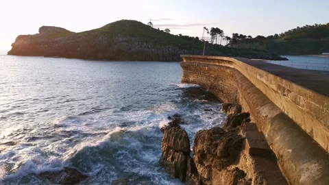 Waves breaking on the Lekeitio pier Stock Footage 133464413