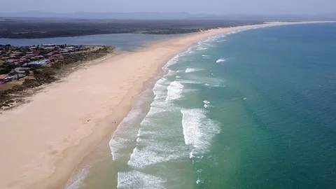 Waves breaking on long sandy beach Stock Footage 71614550