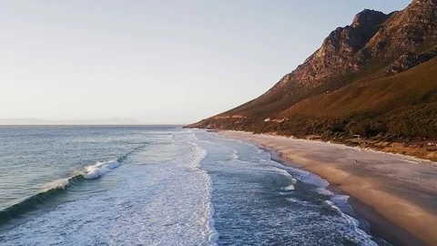 Waves breaking on long sandy beach Stock Footage 71614994