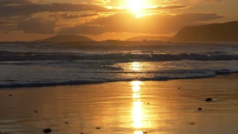 Waves breaking on North Wales beach during sunset Stock Footage 141533102
