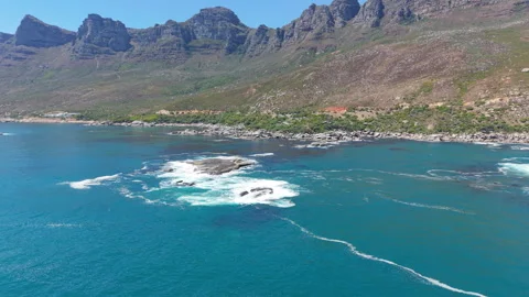Waves Breaking Over Coastal Rocks Beneath the Twelve Apostles Mountains Stock Footage 330317666