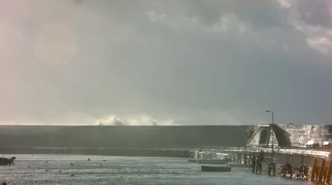 Waves breaking over The Cobb Harbour wall, Lyme Regis Stock Footage 33962775