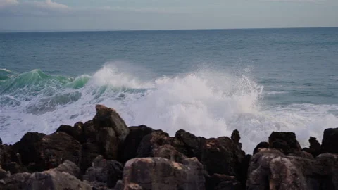 Waves breaking over dangerous rocks. Awesome power of waves breaking over Stock Footage 304708425