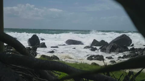 Waves breaking over dark rocks Stock Footage 297719287