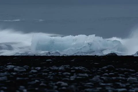 Waves breaking over the iceberg, long exposure 스톡 사진