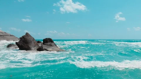 Waves breaking over large rocks aerial Stock Footage 111643628