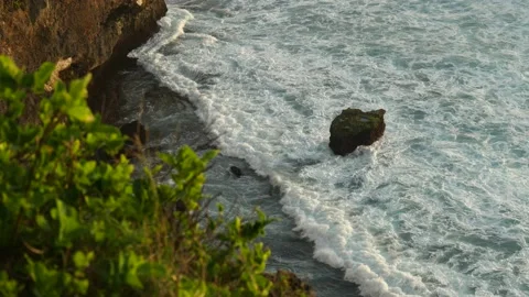 WAVES BREAKING OVER ROCK BIRDS EYE Stock Footage 221301528