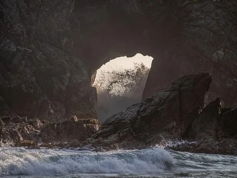 Waves breaking over the rocks Stock Photos