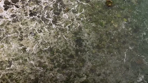 Waves breaking over rocks in slow motion from above. top down aerial view Stock Footage 124891054
