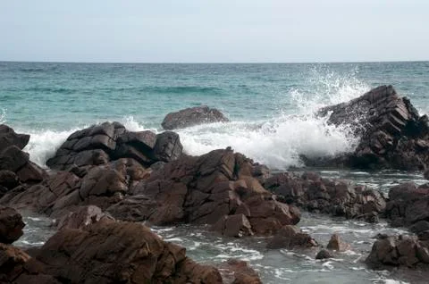 Waves breaking over rocks at Stokes Bay Stock Photos