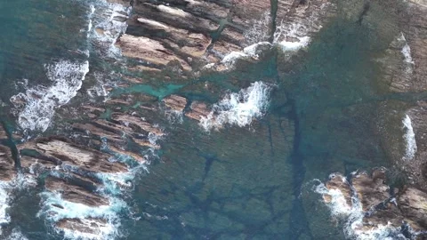 Waves breaking over submerged rocks in clear coastal water Video stock 342305513