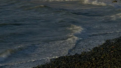 Waves breaking on a pebble beach Stock Footage 73890256