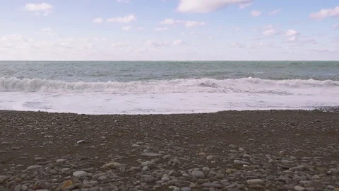 Waves breaking on a pebble beach Stock-Footage 82789567