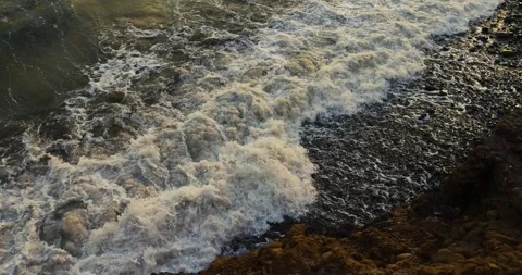 Waves breaking on a pebbly beach Stock Footage 243420555