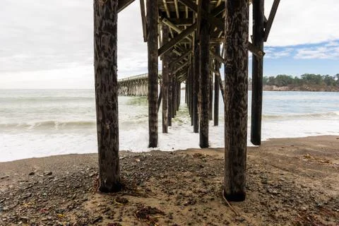Waves breaking on the poles under the pier of San Simeon, California, USA Stock Photos