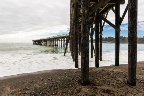 Waves breaking on the poles under the pier of San Simeon, California, USA Stock Photos