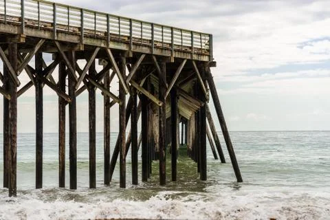 Waves breaking on the poles under the pier of San Simeon, California, USA Stock Photos