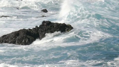 Waves breaking on a rock in water Video stock 70694774